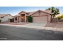Inviting single-story home features a well-manicured yard and a spacious two-car garage at 1220 S Wagon Wheel Dr, Chandler, AZ 85286