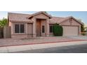 Beautiful exterior of home with neutral stucco, tile roof, well maintained yard, and inviting entrance at 1220 S Wagon Wheel Dr, Chandler, AZ 85286