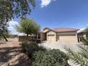 Attractive home with desert landscaping, a tile roof, and a spacious three car driveway at 1248 W Deoni Trl, San Tan Valley, AZ 85143