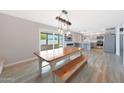 Bright dining room featuring wood table, light fixture and access to the outdoor patio at 12627 N 25Th Ave, Phoenix, AZ 85029