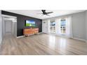 Relaxing living room with large windows, ceiling fan, modern furniture at 12627 N 25Th Ave, Phoenix, AZ 85029