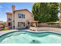 Private backyard with a refreshing pool, patio, and lush landscaping, perfect for relaxation at 1310 E Helena Dr, Phoenix, AZ 85022