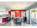 Bright dining room featuring a modern chandelier and access to the backyard through sliding glass doors at 1310 E Helena Dr, Phoenix, AZ 85022