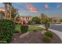 Beautifully landscaped front yard featuring vibrant flowers, decorative rocks and lush green lawn at 1356 E Flamingo Ct, Gilbert, AZ 85297