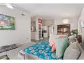 Bright living room with light gray walls and carpet, providing a clear view into the kitchen at 1803 E Palm Beach Dr, Chandler, AZ 85249