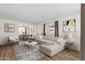 Bright living room features a neutral color palette, stylish furniture, and large windows for natural light at 1944 W Osborn Rd, Phoenix, AZ 85015