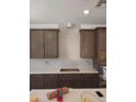 Kitchen with white backsplash, white countertop, brown cabinets, and stainless steel appliances ready for installation at 2469 W Rowel Rd, Phoenix, AZ 85085