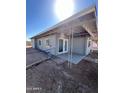 The covered patio offers an outdoor retreat with access from the backyard and through glass doors at 2853 W Ohio St, Apache Junction, AZ 85120