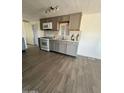 Updated kitchen features gray cabinets, stainless steel appliances, and sleek countertop at 2853 W Ohio St, Apache Junction, AZ 85120