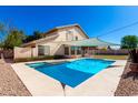 Backyard featuring sparkling pool, spa, shade sail, and privacy landscaping at 3761 W Kent Dr, Chandler, AZ 85226