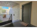 Hallway entrance to unit 201 with apartment number above the door and a door mat in front at 4120 N 78Th St # 201, Scottsdale, AZ 85251