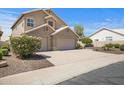 Lovely two-story home featuring a three-car garage and desert landscaping at 4207 E Rockledge Rd, Phoenix, AZ 85044