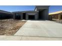 New construction featuring a gray single-Gathering home with a concrete driveway and garage at 47230 W Cansados Rd, Maricopa, AZ 85139