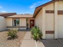 A lovely home exterior featuring desert landscaping and a charming red front door at 5517 W Commonwealth Pl, Chandler, AZ 85226