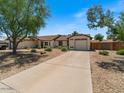 Traditional single-story home featuring a front-facing two-car garage and desert landscaping at 5517 W Commonwealth Pl, Chandler, AZ 85226