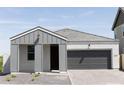 Stylish single-story home showing a gray exterior, tiled roof, and a spacious two-car garage at 5716 S Daisy Patch Pl, Phoenix, AZ 85040