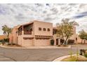 Elegant stucco home with a three-car garage, balcony, and desert landscaping at 6411 S River Dr # 28, Tempe, AZ 85283
