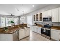 Well-lit kitchen featuring white cabinets, stainless steel appliances, and stylish countertops at 6742 W El Cortez Pl, Peoria, AZ 85383