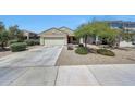 Well-maintained single-story home featuring desert landscaping, a two-car garage, and a charming front yard tree at 7236 W Townley Ave, Peoria, AZ 85345