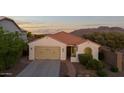 Attractive single-story home featuring desert landscaping, tile roof, and mountain views in the distance at 7973 S Peppertree Ct, Gilbert, AZ 85298