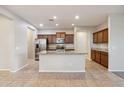 Bright kitchen with granite countertops, a stainless steel refrigerator, and custom cabinetry at 7973 S Peppertree Ct, Gilbert, AZ 85298