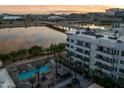 Scenic view of apartments by the water with palm trees and a glimpse of a luxurious pool area at 945 E Playa Del Norte Dr # 1022, Tempe, AZ 85288