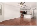 Open concept living area with wood-look floors, kitchen, and natural light at 9820 N Central Ave # 307, Phoenix, AZ 85020