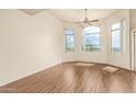 Bright and airy living room with wood floors, multiple windows, and a ceiling fan at 9820 N Central Ave # 324, Phoenix, AZ 85020