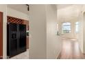 Open-concept living space featuring modern flooring, natural light, and view into an adjacent modern kitchen at 9820 N Central Ave # 324, Phoenix, AZ 85020