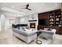 Open living space featuring a fireplace, built-in shelving, comfortable seating, and a formal dining area at 9865 E Piedra Dr, Scottsdale, AZ 85255