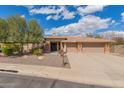Charming single-story home featuring desert landscaping, a tile roof, and an inviting front facade with lots of curb appeal at 104 E Louis Way, Tempe, AZ 85284