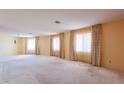 Expansive living room with carpet and multiple large windows providing natural light at 1156 E Brenda Dr, Casa Grande, AZ 85122