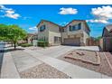 Beautiful two-story home with a manicured lawn, mature trees, and a paved driveway at 11785 N 143Rd Dr, Surprise, AZ 85379