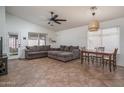 Spacious living room featuring vaulted ceilings, neutral paint, with a decorative ceiling fan and a dining table at 13034 W Cheery Lynn Rd, Avondale, AZ 85392