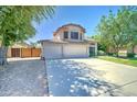 Charming home with a three-car garage, spacious driveway, and a well-maintained front yard at 1361 E Sheffield Ave, Gilbert, AZ 85296