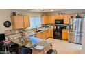 Well-lit kitchen featuring granite countertops, stainless steel appliances, and ample cabinet space at 14968 N 134Th Ln, Surprise, AZ 85379