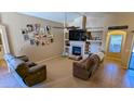 Inviting living room with tile floors, a fireplace, and built-in shelving at 14968 N 134Th Ln, Surprise, AZ 85379