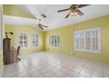 Spacious, sun-filled room with tile floors and multiple ceiling fans at 15034 S 44Th Pl, Phoenix, AZ 85044