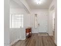 Bright foyer with wood floors, white walls, and staircase at 19042 E Arrowhead Trl, Queen Creek, AZ 85142