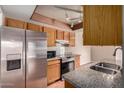 Traditional kitchen featuring stainless steel appliances, granite countertops, and warm wood cabinetry at 1976 N Lemon Tree Ln # 16, Chandler, AZ 85224