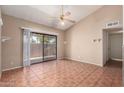 Bright living room featuring ceramic tile flooring, vaulted ceilings, and sliding glass door for natural light at 1976 N Lemon Tree Ln # 16, Chandler, AZ 85224