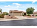 A single-story home featuring desert landscaping, a tile roof, and a two-car garage at 20450 N Shadow Mountain Dr, Surprise, AZ 85374