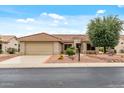 Single-story home with desert landscaping, tile roof, and attached two-car garage in Arizona at 20450 N Shadow Mountain Dr, Surprise, AZ 85374