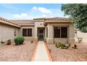 Welcoming front entrance with desert landscaping, a tiled path, and security door at 20450 N Shadow Mountain Dr, Surprise, AZ 85374