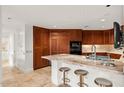 Spacious kitchen with custom cabinetry, marble countertops, and stainless steel appliances at 2402 E Esplanade Ln # 204, Phoenix, AZ 85016