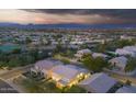 Stunning aerial view of the neighborhood homes at dusk with mountain backdrop and beautiful desert landscape at 29228 N 48Th St, Cave Creek, AZ 85331