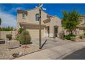 Two-story home with desert landscaping, tile roof, and a two-car garage at 29399 N 67Th Ave, Peoria, AZ 85383