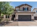 Charming two-story home with a spacious driveway, desert landscaping, and a convenient two-car garage at 3067 E Trigger Way, Gilbert, AZ 85297