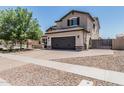 Charming two-story home showcasing desert landscaping, a spacious driveway, and a two-car garage at 3067 E Trigger Way, Gilbert, AZ 85297