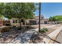 Inviting street view of home showcasing desert landscaping, and convenient two-car garage at 3067 E Trigger Way, Gilbert, AZ 85297